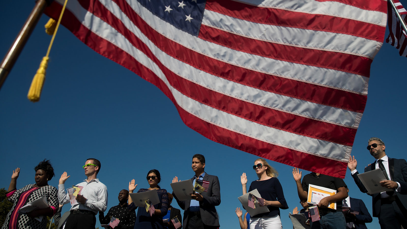 people in front of American flag