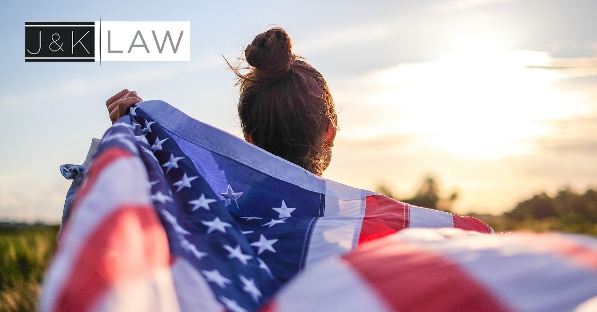 Woman holding U.S flag behind her
